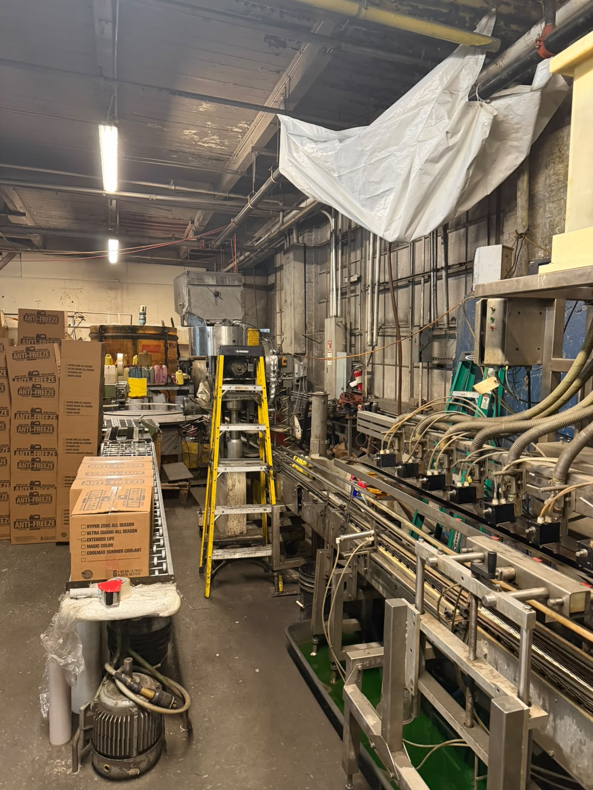 The filling and packaging line at Bass Oil with antifreeze cases on the conveyor