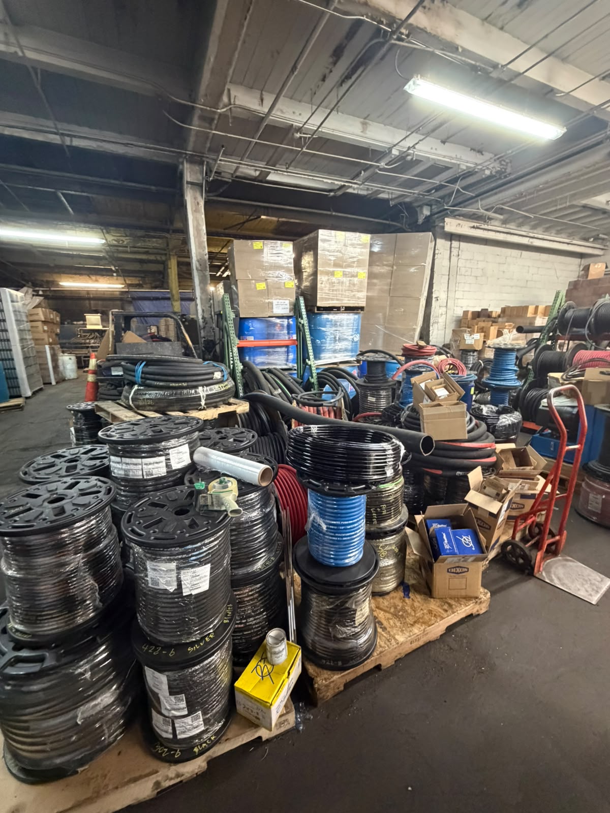 Hose reels and bulk hose on pallets in the Bass Oil warehouse