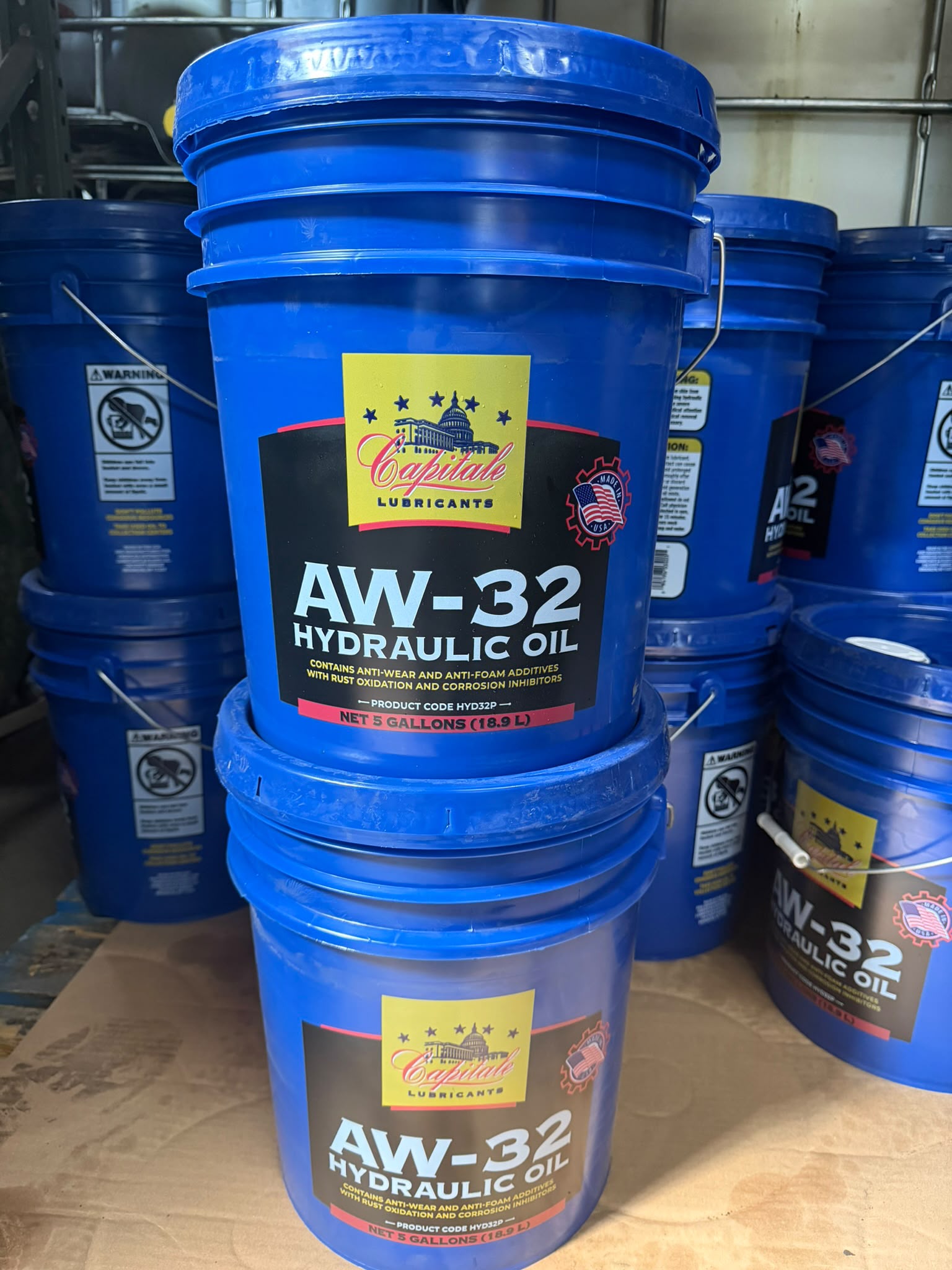 Cases of Capitale AW-32 hydraulic oil stacked in the Bass Oil warehouse