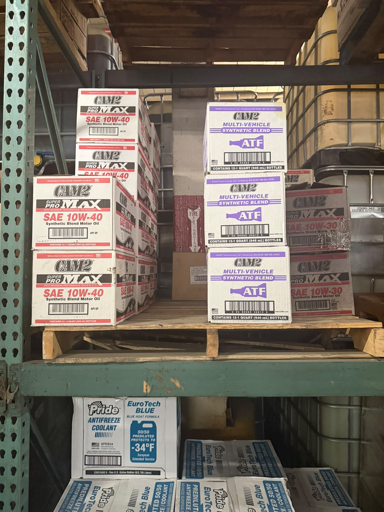CAM2 Super Pro Max SAE 10W-40 Synthetic Blend Motor Oil and CAM2 Multi-Vehicle Synthetic Blend ATF cases at the Bass Oil warehouse in Brooklyn