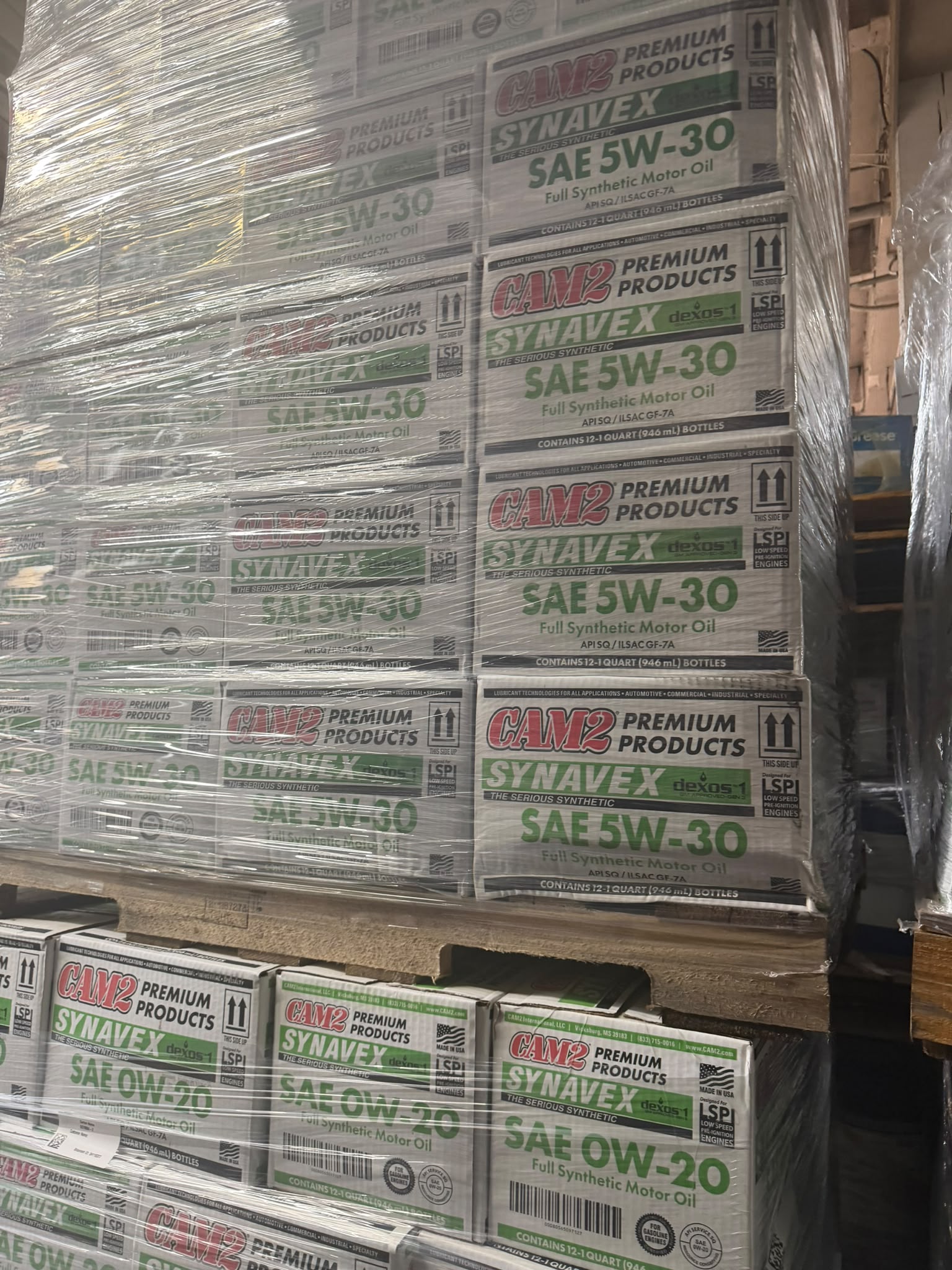 Pallet of CAM2 Synavex dexos1 SAE 5W-30 Full Synthetic Motor Oil with 0W-20 cases stacked below at the Bass Oil warehouse in Brooklyn