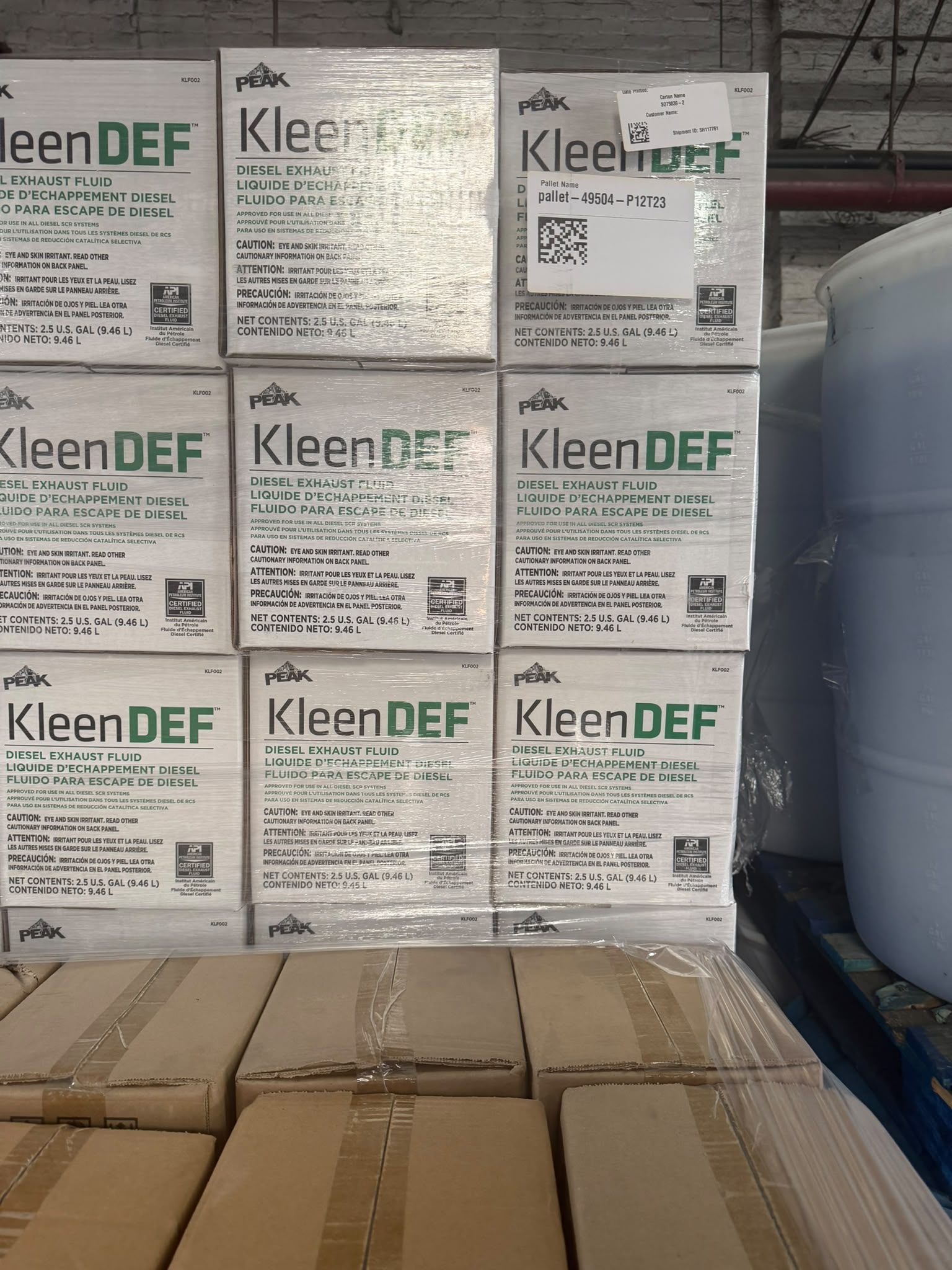 Cases of PEAK KleenDEF diesel exhaust fluid, 2.5 gallon, on a pallet at the Bass Oil warehouse in Brooklyn