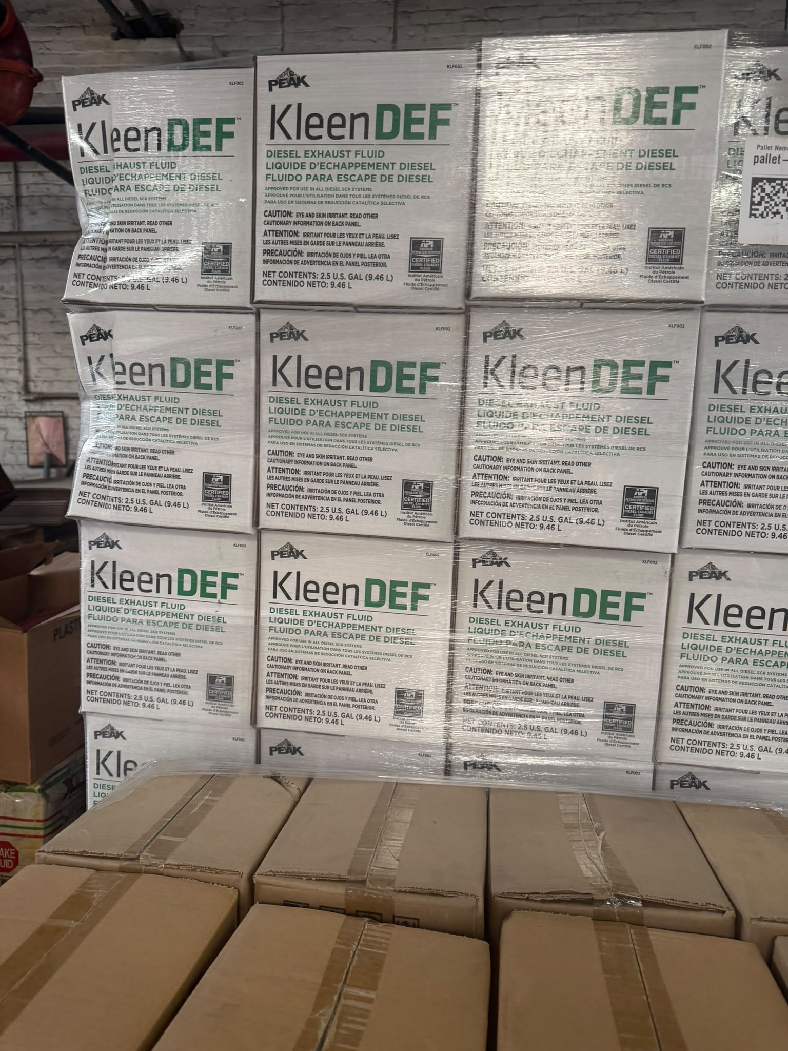 Pallet of PEAK KleenDEF diesel exhaust fluid cases at the Bass Oil warehouse in Brooklyn